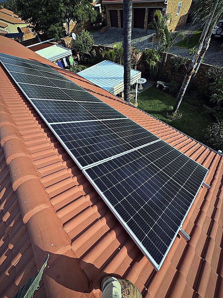 Solar panels being cleaned on a pitched roof