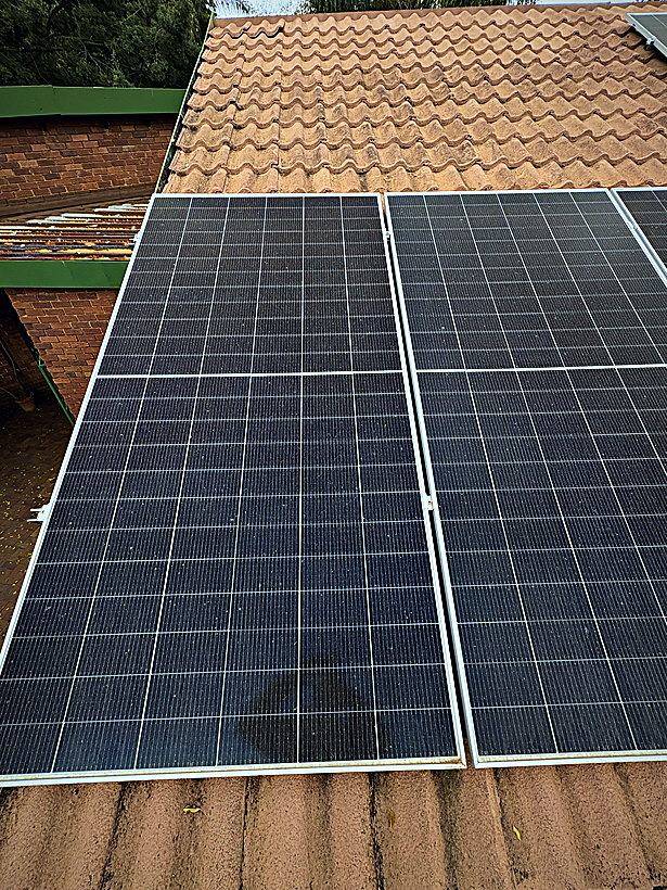Clean solar panels on a pitched tile roof